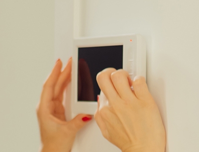 Woman checking thermostat